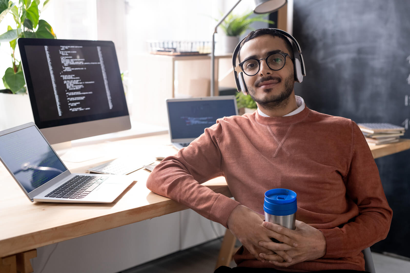 handsome-programmer-in-headphones-listening-to-mus-2023-11-27-04-56-48-utc